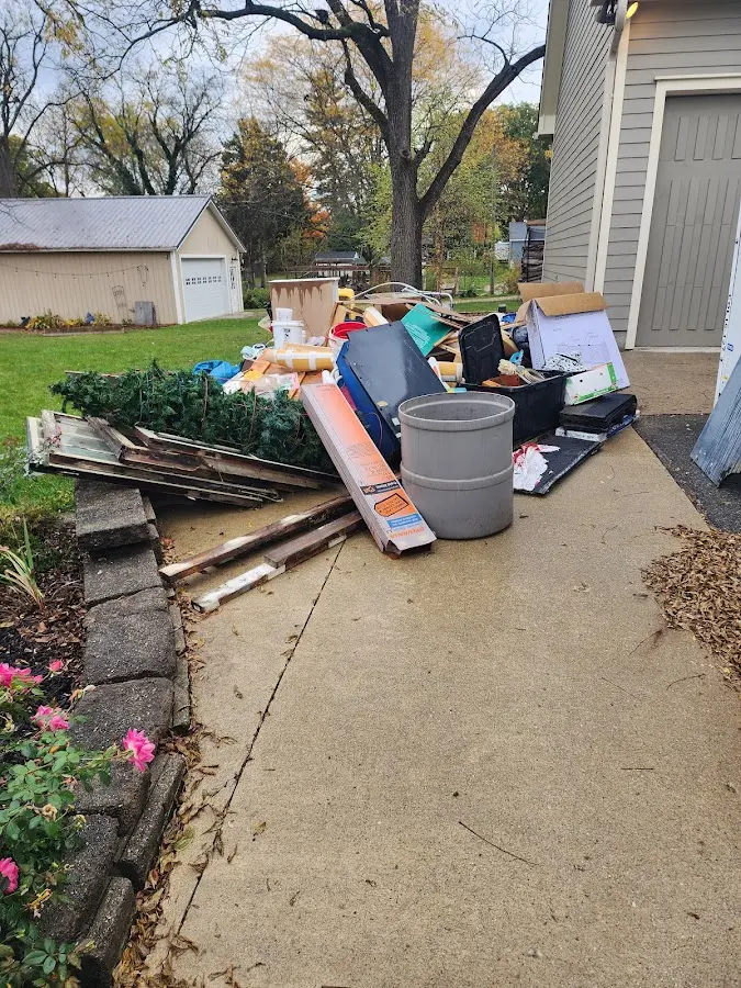Dumpster being loaded with debris for 12 Yard Dumpster Rental in Massillon